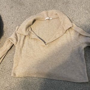 Cream colored long sleeve collared sweater top